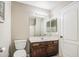 Cozy bathroom featuring a single vanity, wood cabinets, a shower-tub combination, and neutral finishes at 836 N Sinova Ave, Gilbert, AZ 85234