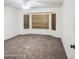 Carpeted bedroom featuring a bay window with wood blinds for natural light at 836 N Sinova Ave, Gilbert, AZ 85234