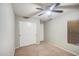This carpeted bedroom features a ceiling fan and a closet with sliding doors at 836 N Sinova Ave, Gilbert, AZ 85234