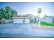Charming single-story home featuring a well-maintained front yard, mature trees, and a two-car garage at 836 N Sinova Ave, Gilbert, AZ 85234