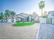 Lovely single-story home boasting desert landscaping, a well-manicured lawn, and a two-car garage at 836 N Sinova Ave, Gilbert, AZ 85234