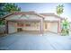 This spacious three-car garage has an open door and cabinet storage at 836 N Sinova Ave, Gilbert, AZ 85234