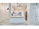 The sleek kitchen features stainless appliances, white cabinetry, and an eat-in counter at 836 N Sinova Ave, Gilbert, AZ 85234