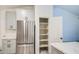 Modern kitchen boasts stainless appliances, gray cabinets, and a walk-in pantry at 836 N Sinova Ave, Gilbert, AZ 85234