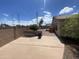 This backyard features concrete, decorative gravel, and a block wall; perfect for easy maintenance and privacy at 8738 W Griswold Rd, Peoria, AZ 85345
