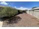 The backyard of this property features decorative gravel for easy maintenance and is surrounded by a block wall at 8738 W Griswold Rd, Peoria, AZ 85345
