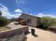 This home features a low-maintenance backyard with decorative gravel and a block wall for privacy at 8738 W Griswold Rd, Peoria, AZ 85345