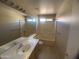 Bathroom with a single sink vanity, tub with shower, and tile flooring, offering a functional space at 8738 W Griswold Rd, Peoria, AZ 85345