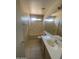Bathroom with a single sink vanity, tub with shower, and tile flooring, offering a functional space at 8738 W Griswold Rd, Peoria, AZ 85345