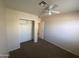 Standard bedroom featuring carpet floors, a closet, and a ceiling fan at 8738 W Griswold Rd, Peoria, AZ 85345