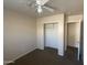 Cozy bedroom features a ceiling fan, closet, and a door to another room at 8738 W Griswold Rd, Peoria, AZ 85345