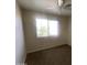 Bright bedroom features neutral colors, a ceiling fan, and a large window for natural light at 8738 W Griswold Rd, Peoria, AZ 85345
