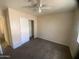Neutral bedroom featuring carpet floors, a sliding-door closet, and a ceiling fan at 8738 W Griswold Rd, Peoria, AZ 85345