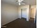 Bedroom with closet, carpet, ceiling fan, and a neutral color scheme at 8738 W Griswold Rd, Peoria, AZ 85345