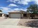 Charming home featuring a tile roof, two-car garage, and low maintenance front yard landscaping at 8738 W Griswold Rd, Peoria, AZ 85345