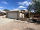 Charming home featuring a tile roof, two-car garage, and low maintenance front yard landscaping at 8738 W Griswold Rd, Peoria, AZ 85345