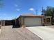 Spacious two-car garage and driveway, complemented by a low-maintenance gravel yard and gated dog run at 8738 W Griswold Rd, Peoria, AZ 85345