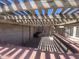 Covered pergola area with a block wall surround for privacy and shade, offering a relaxed outdoor space at 8738 W Griswold Rd, Peoria, AZ 85345