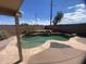 Backyard pool with rock waterfall, stone surround, and desert landscaping at 8738 W Griswold Rd, Peoria, AZ 85345