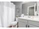 Well-lit bathroom with wood-look flooring, tub shower, and a sink with storage at 8828 N 102Nd Ln, Peoria, AZ 85345