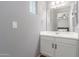 Neutral bathroom features a single sink, cabinet with dark pulls and vinyl flooring at 8828 N 102Nd Ln, Peoria, AZ 85345