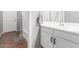 Bathroom with a tub/shower, single sink, storage and wood-look floors at 8828 N 102Nd Ln, Peoria, AZ 85345
