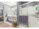 Bathroom featuring a tile floor, a double sink vanity, and a glass door walk-in shower at 8828 N 102Nd Ln, Peoria, AZ 85345