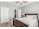 Well-lit bedroom with plush carpet, ceiling fan and a view of the closet and hall at 8828 N 102Nd Ln, Peoria, AZ 85345