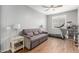Cozy bedroom featuring a sofa bed, ceiling fan, and wood-look tile flooring at 8828 N 102Nd Ln, Peoria, AZ 85345