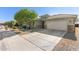 Charming single-story home showcasing a well-manicured front yard and a two-car garage at 8828 N 102Nd Ln, Peoria, AZ 85345