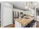 Open kitchen features a granite counter top island with stool seating, stainless appliances and white cabinetry at 8828 N 102Nd Ln, Peoria, AZ 85345