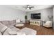Inviting living room featuring a large sectional sofa and modern entertainment center at 8828 N 102Nd Ln, Peoria, AZ 85345