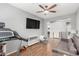 Open-concept living room with sleek ceiling fan and wood-look tile flooring at 8828 N 102Nd Ln, Peoria, AZ 85345