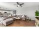 Inviting living room featuring a large sectional sofa and modern entertainment center near kitchen at 8828 N 102Nd Ln, Peoria, AZ 85345