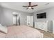 Large bedroom features a ceiling fan, neutral colors and ensuite bathroom and walk-in closet at 8828 N 102Nd Ln, Peoria, AZ 85345