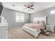 Main bedroom featuring neutral colors, a ceiling fan, shuttered windows and ensuite bathroom at 8828 N 102Nd Ln, Peoria, AZ 85345