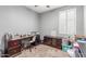 Dedicated office space bathed in natural light featuring carpeted floors and comfortable seating at 8828 N 102Nd Ln, Peoria, AZ 85345