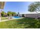 Inviting pool area complete with artificial turf, privacy landscaping, and lounge chairs at 8828 N 102Nd Ln, Peoria, AZ 85345