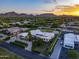 Modern home with meticulously manicured grounds, a sport court, and a view of the mountains at 9148 N 66Th Pl, Paradise Valley, AZ 85253