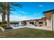 Expansive backyard featuring a luxurious pool, lounge area, modern patio furniture, and well-maintained landscaping at 9148 N 66Th Pl, Paradise Valley, AZ 85253