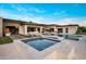 Stylish outdoor living space showcasing a pool, jacuzzi, and comfortable lounge seating at 9148 N 66Th Pl, Paradise Valley, AZ 85253