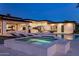 Backyard oasis features a pristine pool, relaxing lounge chairs, and a cozy spa for ultimate relaxation and entertainment at 9148 N 66Th Pl, Paradise Valley, AZ 85253