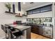 Stylish home bar featuring dark wood cabinets, sleek countertops, and ample storage for beverages at 9148 N 66Th Pl, Paradise Valley, AZ 85253