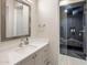 Elegant bathroom with a modern sink, vanity, decorative mirror, and a spacious glass-enclosed shower at 9148 N 66Th Pl, Paradise Valley, AZ 85253