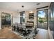 Formal dining room with a large table, seating for ten, and a view of the outdoor landscaping at 9148 N 66Th Pl, Paradise Valley, AZ 85253