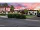 Beautiful exterior of a modern home with palm trees, a well-maintained lawn, and a circular driveway at 9148 N 66Th Pl, Paradise Valley, AZ 85253