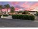 Charming single-story home featuring desert landscaping and a modern architectural design under a sunset sky at 9148 N 66Th Pl, Paradise Valley, AZ 85253