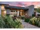 Stunning modern home featuring a landscaped front yard leading to the entryway and a sleek, contemporary design at 9148 N 66Th Pl, Paradise Valley, AZ 85253
