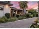 Lovely front exterior featuring a landscaped yard with flowers, bushes and a driveway leading to the modern home at 9148 N 66Th Pl, Paradise Valley, AZ 85253