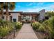 Contemporary home showcasing a beautifully landscaped front yard with vibrant plants and a quaint walkway at 9148 N 66Th Pl, Paradise Valley, AZ 85253